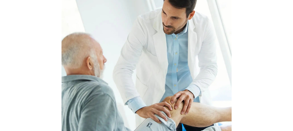 doctor evaluating knee of elder patient