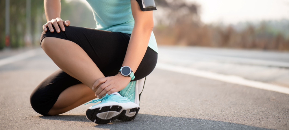 woman in athletic gear with ankle pain