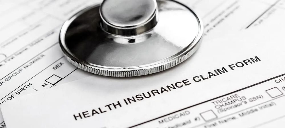 insurance documents with stethoscope on top