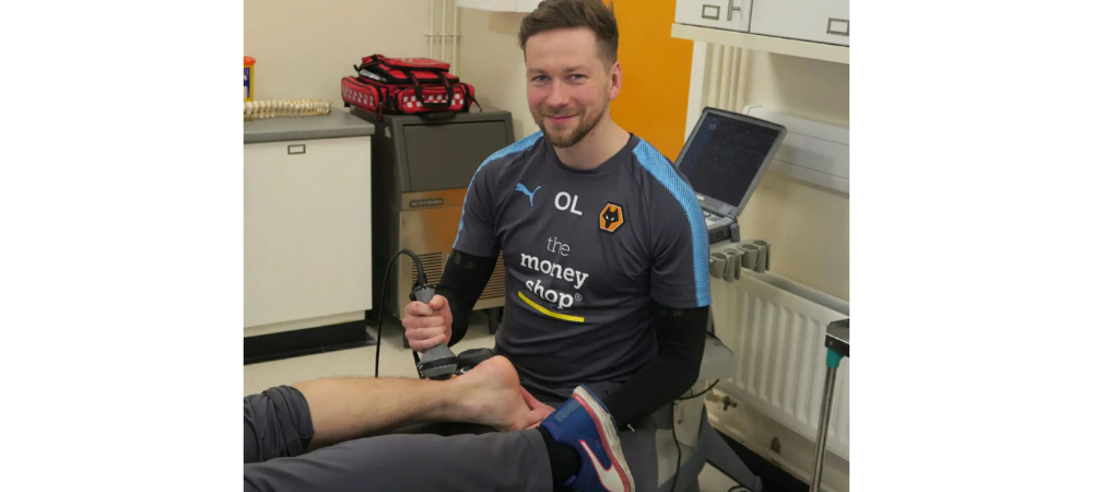 clinician applying laser to patient ankle