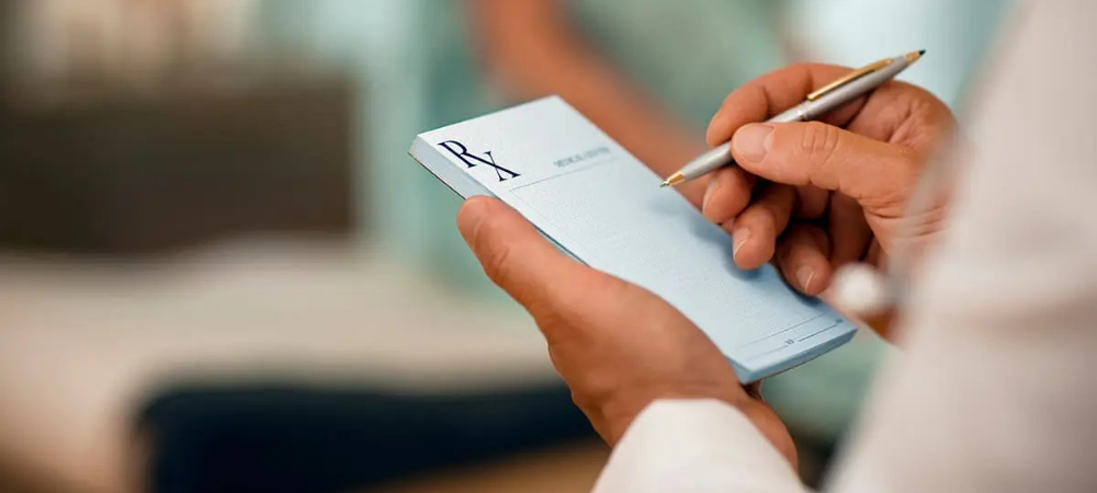 clinician writing on prescription pad