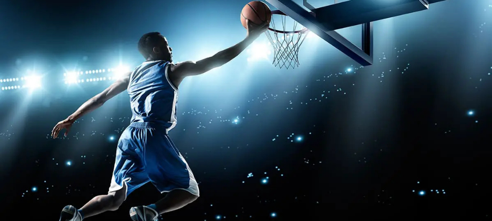 basketball player jumping to net