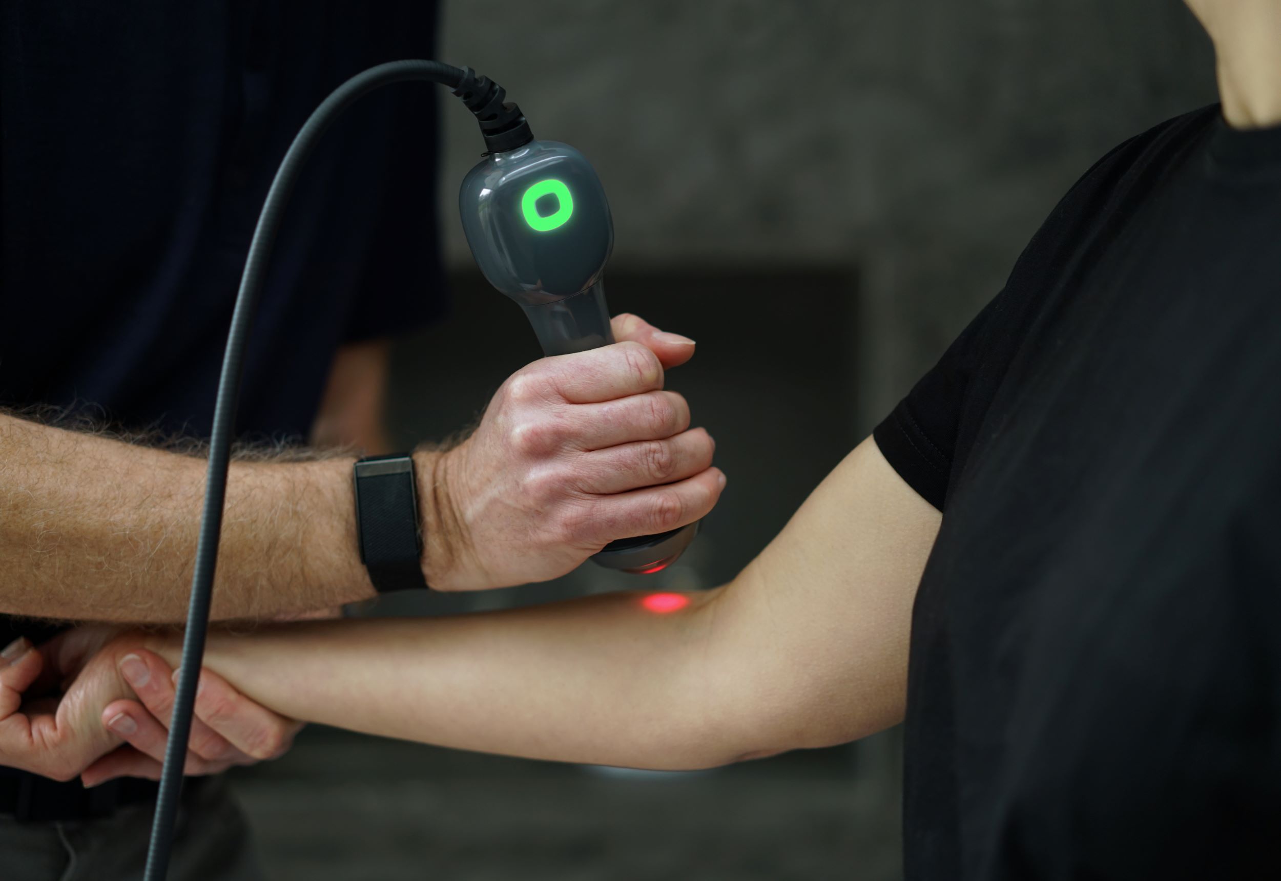 patient receiving laser therapy on arm