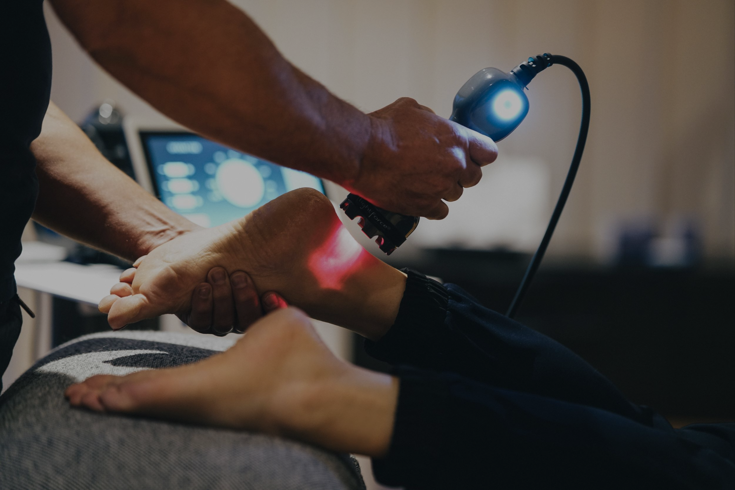 doctor using laser on patient foot