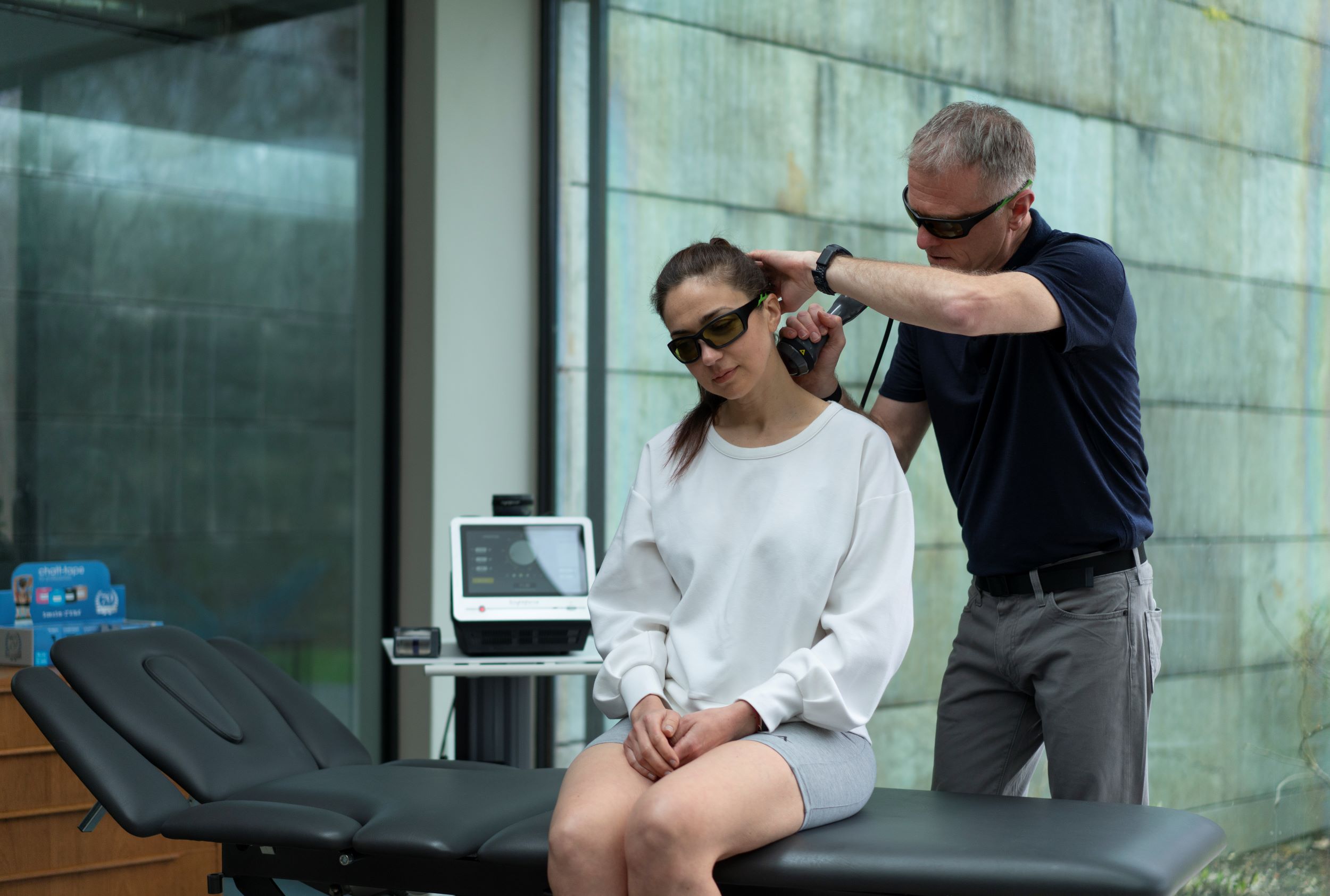 woman receiving laser therapy on neck