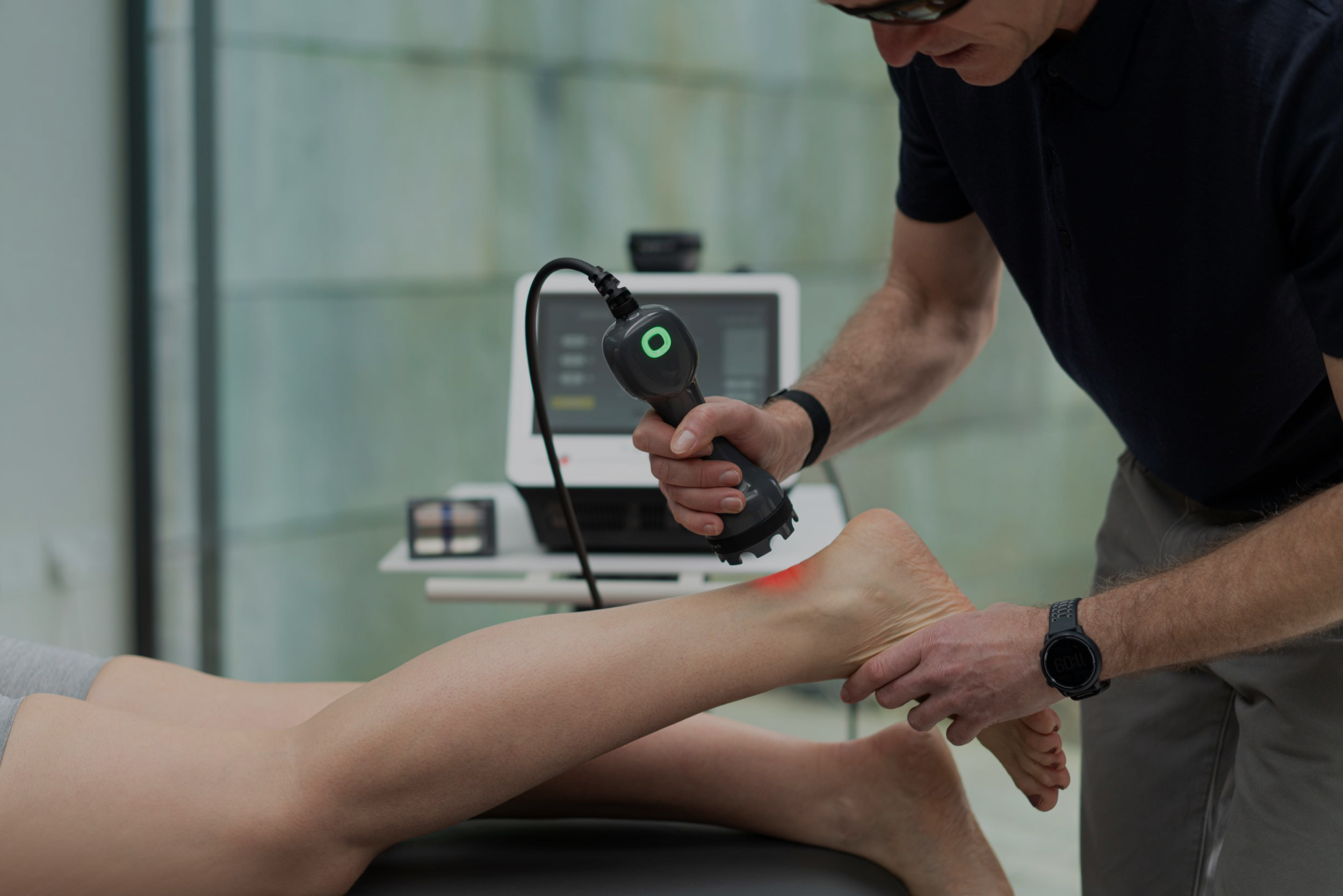laser therapy on patient ankle
