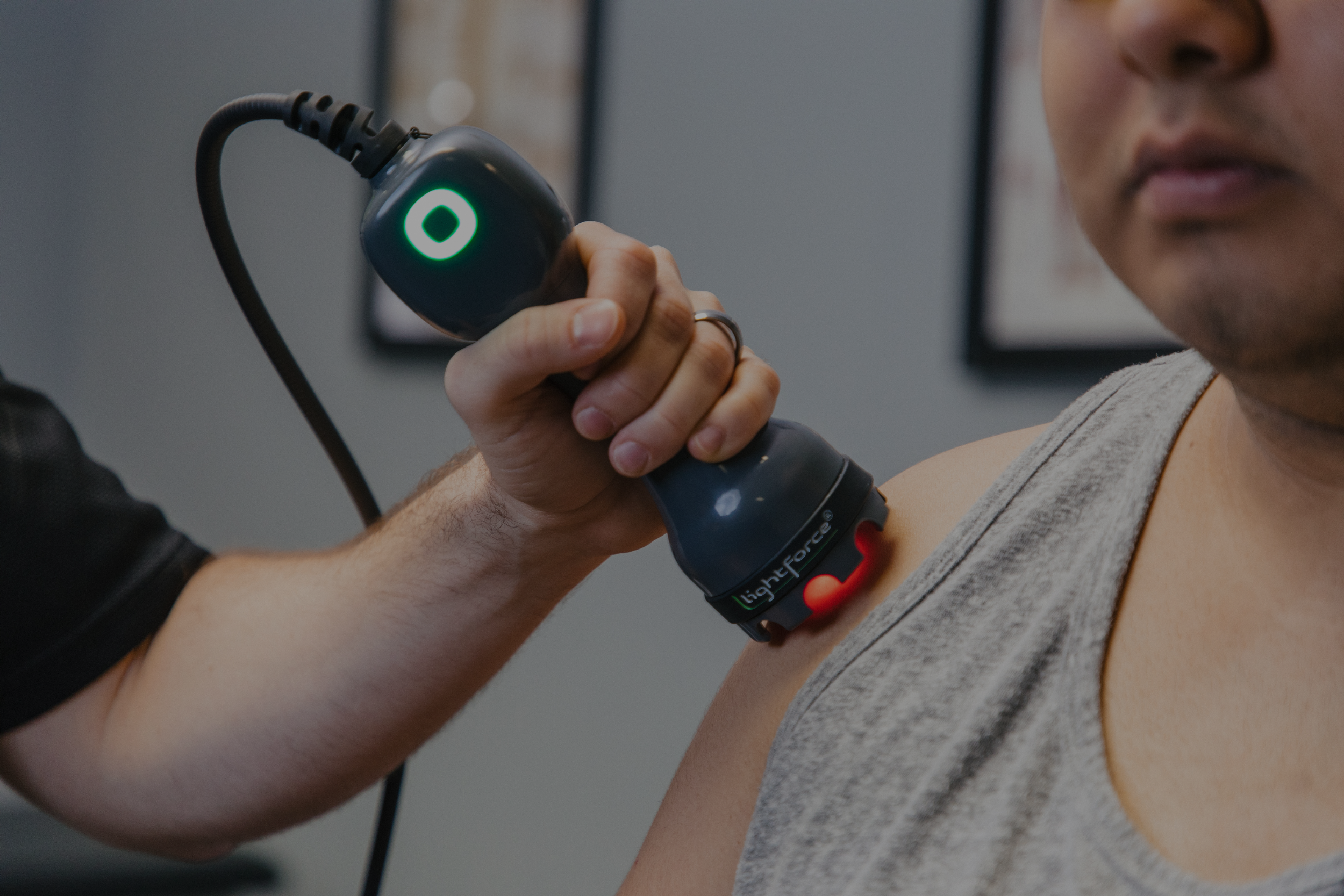 laser therapy on patient shoulder